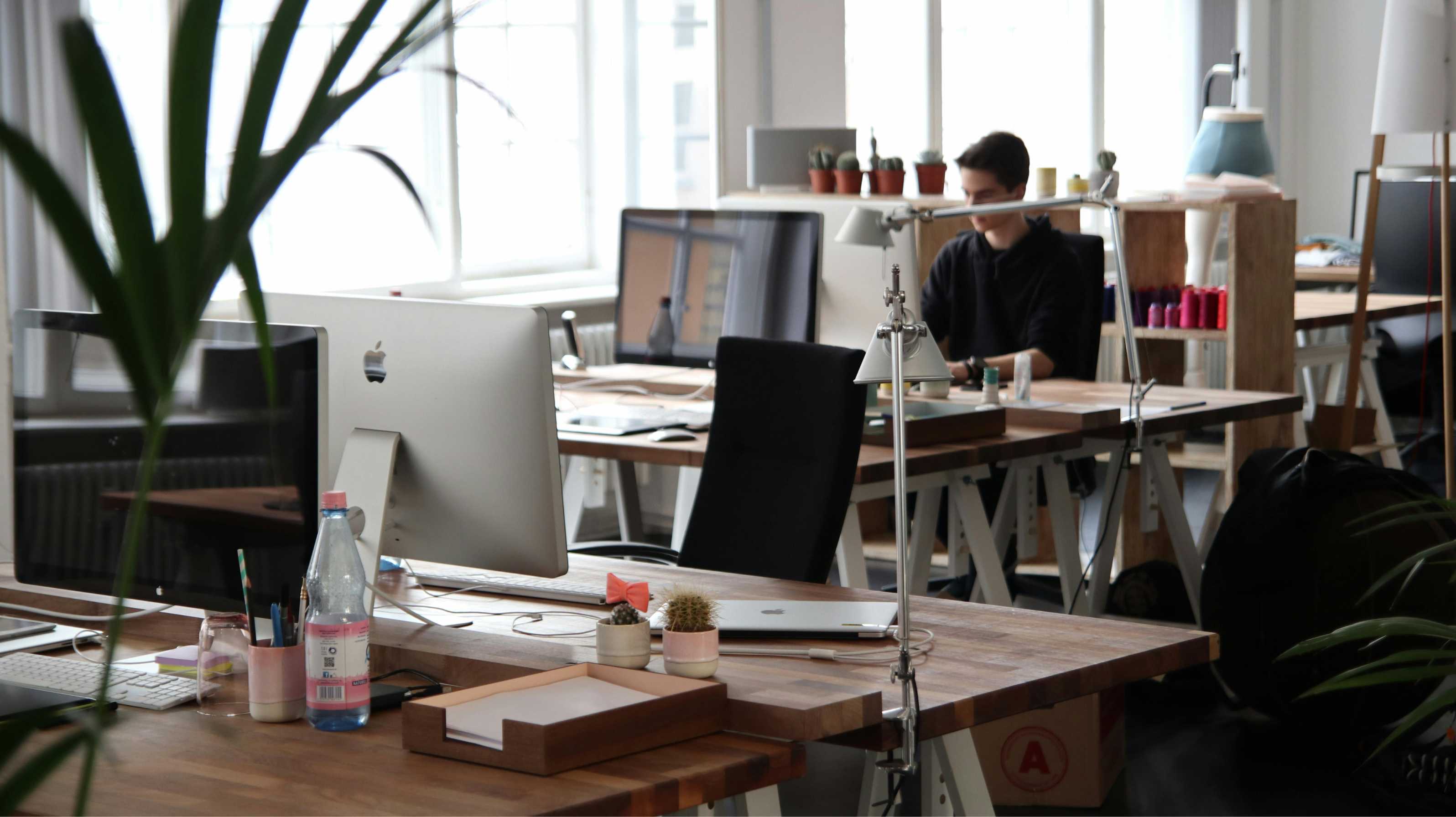 office with desks and person working